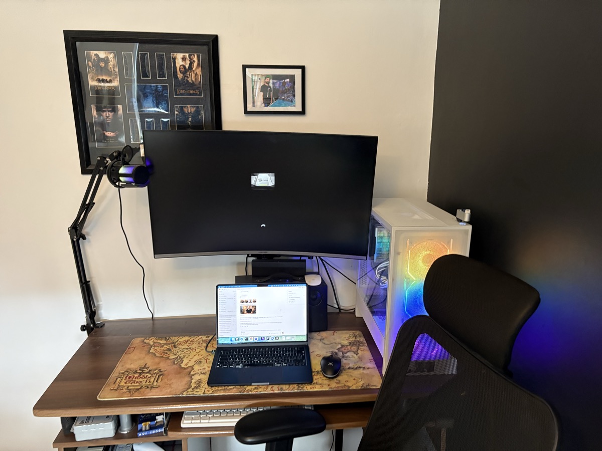 Reference photograph of my desk, microphone, monitors, white PC and chair.